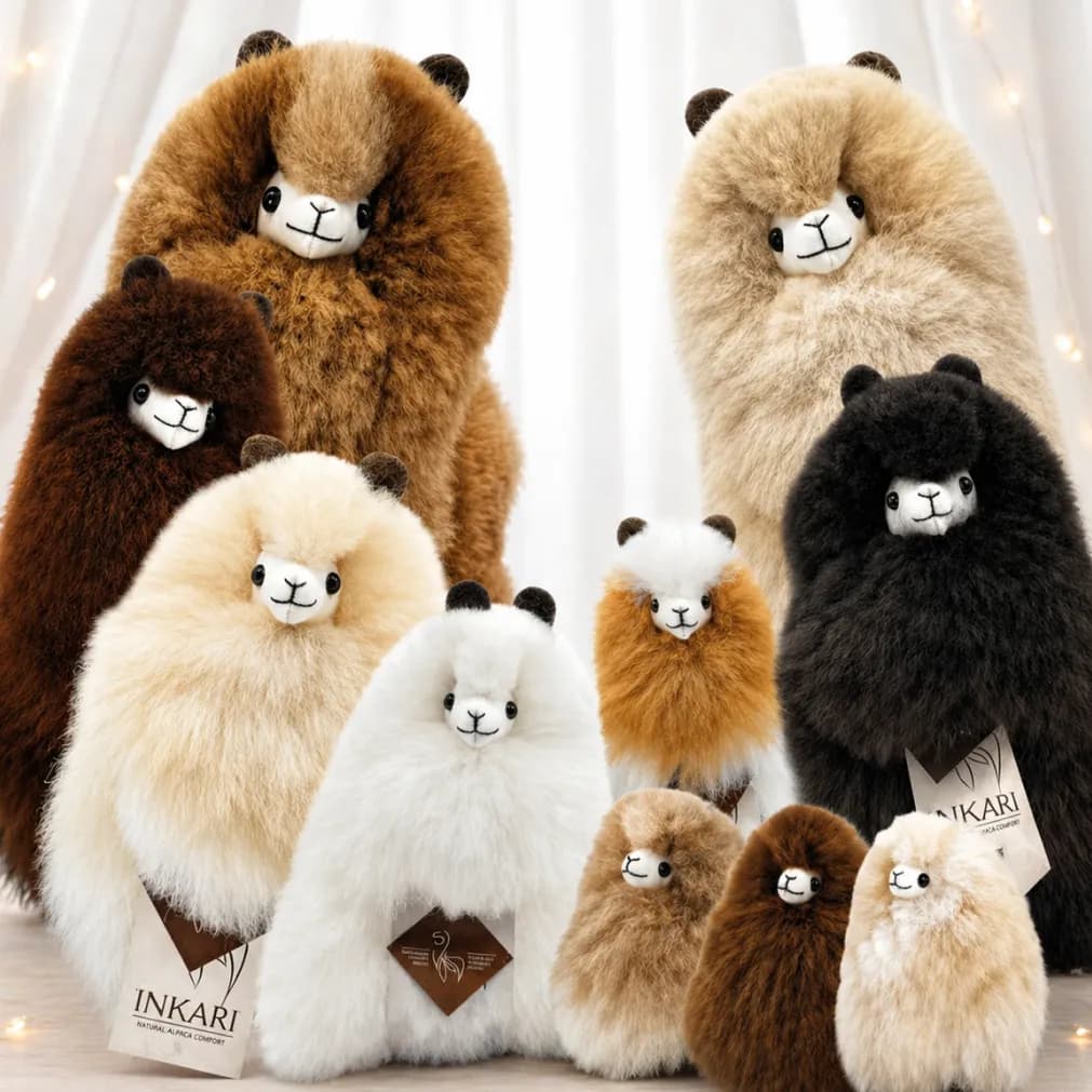 A group of Inkari plush alpacas in natural colours